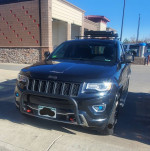 2015 Jeep Cherokee Sport FWD, fully loaded with advanced tech and off-road features, parked in a service area.