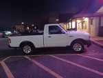 2011 Ford Ranger XL RWD parked at night, showcasing clean body and silver wheels with low mileage