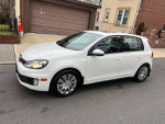 2011 Volkswagen Golf GTI in white, showcasing stylish design and clean condition, parked on a residential street.