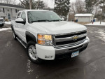 2011 Chevrolet Silverado 1500 LTZ 4WD in white with black accents, showcasing a clean exterior and winter setting.
