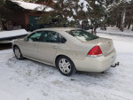 2012 Chevrolet Impala LT in a snowy setting, well-maintained, with new tires and low mileage.