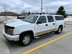2006 Chevrolet Silverado 1500 Z71 in white with service records, located outdoors on a cloudy day.
