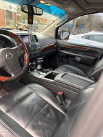 Interior view of 2011 Nissan Armada Platinum edition showcasing leather seats and dashboard features.