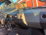 Interior view of a 2004 Ford F150 XLT showing dashboard and controls.