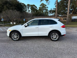 2013 Porsche Cayenne in white with tan interior, parked, showcasing its clean condition and modern features.