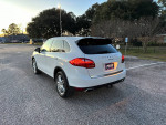 2013 Porsche Cayenne in white parked, showcasing excellent mechanical and cosmetic condition with sunroof and navigation.