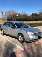 2004 Chevrolet Malibu in silver color parked outdoors with a clear sky, showcasing its sleek design and overall condition.