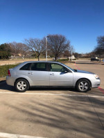 2004 Chevrolet Malibu Maxx, silver, parked in a parking lot, showcasing its sleek design and good condition.