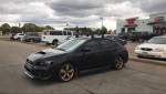 2015 Subaru WRX Limited AWD parked with new wheels and red leather interior, well-maintained and lightly modified.