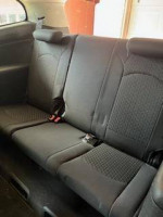 Interior view of the second row seats in a 2011 Chevrolet Traverse LS with dark gray upholstery.