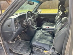 Interior view of a 2000 Chevy 2500 truck with black leather seats and dashboard controls.