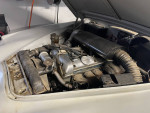 1960 Jaguar MK2 engine bay showing partially completed restoration and refurbished parts.