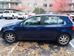 2008 Volkswagen Rabbit in blue for sale, showing side view with minor wear and autumn leaves around.