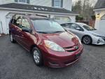 2010 Toyota Sienna LE in excellent condition, 7-passenger seating, front-wheel drive, parked in a driveway