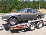 1972 Ferrari Fiat Dino on a trailer, showcasing its classic design and rusted body from long-term storage.
