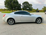2009 INFINITI G37X AWD Coupe in silver parked outdoors near trees