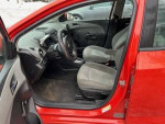 Interior view of 2012 Chevrolet Sonic with gray seats, showing dashboard and controls.