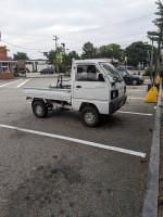 1989 Mazda Scrum KEI truck parked in a lot, ready for errands and outdoor adventures.