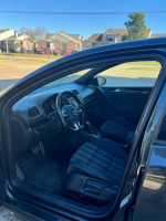 Interior view of a 2015 Jetta GTI showcasing seats, steering wheel, and dashboard features.