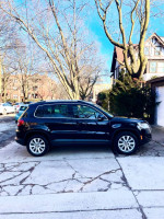 2009 Volkswagen Tiguan SE 4Motion AWD parked outside, showcasing its sleek design and clean condition.