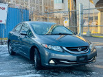 2013 Honda Civic Hybrid in gray, parked on a snowy street, showcasing its clean body and alloy wheels.