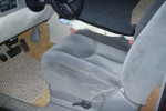 Interior of a 2001 Chevrolet Suburban showing the driver's seat and floor mats, featuring clean upholstery.