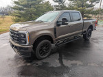 2023 Ford F250 Super Duty Crew Cab with black appearance package, tinted windows, and Baja interior.