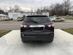 Rear view of a 2015 Chevrolet Traverse LT AWD parked, showcasing its sleek design and backup camera features.