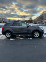 2014 Chevrolet Equinox LT AWD parked in snowy neighborhood with cloudy sky backdrop