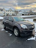 2014 Chevrolet Equinox LT AWD parked on snow-covered driveway with houses in the background