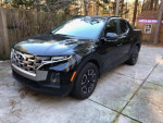 2022 Hyundai Santa Cruz SEL AWD in Phantom Black exterior with charcoal interior, parked outdoors.