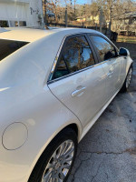 Side view of a white Cadillac CTS sedan with a modified bumper and clean exterior.