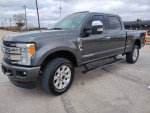 2017 Ford F250 Platinum truck with 98k miles, showcasing clean exterior and good tires on an open road.