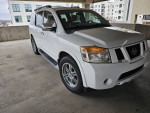 2011 Nissan Armada 4X4 in white with leather seats, backup camera, and parking sensors, parked in a garage.