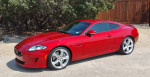 2014 Jaguar XKR Coupe in red, showcasing a sleek design, immaculate condition, and parked outdoors.