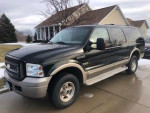 2005 Ford Excursion Eddie Bauer 4WD parked in driveway, showing its black exterior and overall condition.