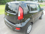 Clean black 2013 Kia Soul Sport SUV parked on a road with nice exterior and windows.