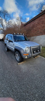 2003 Jeep Liberty Sport 4WD for sale, manual transmission, 65000 miles, with 2-inch suspension lift and working features.
