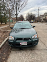 Front view of a 2004 Subaru Impreza in excellent condition, parked on a residential street.