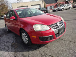 Fire engine red 2007 Volkswagen Jetta 2.5 with 150,000 miles, well-maintained and in great condition.