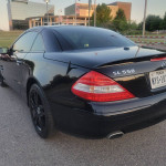 Black 2008 Mercedes-Benz SL 550 parked outdoors, showcasing its sleek design and rear features.