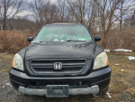 2003 Honda Pilot 4WD SUV for sale with new tires, leather, and DVD, parked off-road