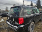 2003 Honda Pilot SUV with black wheels parked, showing rear view and no license plates