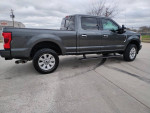 2017 Ford F250 Platinum truck with 98k miles, silver exterior and clean condition, parked on a driveway.