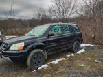 2003 Honda Pilot in black with leather interior and DVD system, parked in a winter landscape.