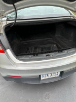 Trunk space of a 2013 Ford Taurus Limited, showing clean interior and no visible damage.