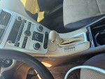 Interior view of a 2010 Chevrolet Malibu showing dashboard controls and seating with low mileage.