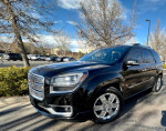 2016 GMC Acadia Denali FWD, black SUV parked outdoors, showcasing chrome wheels and sleek design.