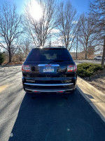 Rear view of a 2016 GMC Acadia Denali with tinted windows and winter-ready features.