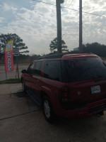 2003 Chevrolet TrailBlazer parked outside with sign, showcasing 127,000 miles, available for sale.